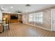 Spacious living room featuring wood paneled walls, tile flooring, and a ceiling fan at 6327 2Nd S Ave, St Petersburg, FL 33707
