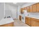 Traditional-style kitchen featuring ample cabinet space, white appliances, and tile flooring at 814 Fern Leaf Dr, Ruskin, FL 33570