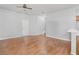 Spacious living room features wood-look flooring, a ceiling fan, and neutral paint, creating an inviting atmosphere at 814 Fern Leaf Dr, Ruskin, FL 33570