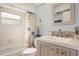 Bright bathroom with modern vanity, tiled backsplash, tub and shower combination and charming accents at 1250 S Pinellas Ave # 713, Tarpon Springs, FL 34689