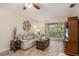 Comfortable living room with stylish decor, wood-look flooring, and a sliding door to the outdoor balcony at 1250 S Pinellas Ave # 713, Tarpon Springs, FL 34689