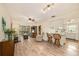 Open-concept living room featuring hardwood floors, a ceiling fan, and a view of the screened-in porch at 1250 S Pinellas Ave # 713, Tarpon Springs, FL 34689