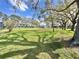 Expansive green lawn area with mature trees, adjacent to the community buildings, offering ample space at 255 114Th N Ave # 4, St Petersburg, FL 33716