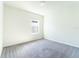 Empty bedroom with large window and plush carpet at 30160 Skylark Dr, Wesley Chapel, FL 33545