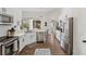 Kitchen featuring white cabinets, stainless steel appliances, and a kitchen sink overlooking the backyard at 4533 River Close Blvd, Valrico, FL 33596