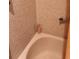 Classic tiled bathtub with shower and towel bar in a compact bathroom space at 5915 18Th N St # 12, St Petersburg, FL 33714