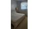 Cozy bedroom featuring a double bed, a lamp, and a view of the outside at 5915 18Th N St # 12, St Petersburg, FL 33714