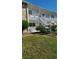 Low angle view of the exterior of a building with greenery and stairs leading to the second floor at 5915 18Th N St # 12, St Petersburg, FL 33714