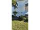 Well-maintained condo exterior featuring lush landscaping and tasteful stone accents at 5915 18Th N St # 12, St Petersburg, FL 33714