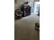 A cozy living room space with neutral carpet and a classic entertainment center at 5915 18Th N St # 12, St Petersburg, FL 33714