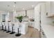 Stylish kitchen with island, pendant lighting, and stainless steel range hood at 6123 Hidden Branch Dr, Apollo Beach, FL 33572