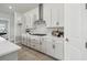 Well-equipped kitchen with white cabinetry, stone backsplash and gas range at 6123 Hidden Branch Dr, Apollo Beach, FL 33572