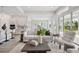 Cozy living room with kitchen view, and sliding glass doors to backyard at 6123 Hidden Branch Dr, Apollo Beach, FL 33572