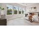 Bright main bedroom with three large windows and stylish decor at 6123 Hidden Branch Dr, Apollo Beach, FL 33572
