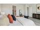 Comfortable main bedroom features a mirror, plenty of natural light, and modern decor at 6123 Hidden Branch Dr, Apollo Beach, FL 33572