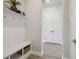 The mudroom features a convenient coat rack and bench, perfect for storing shoes and bags by the door at 6123 Hidden Branch Dr, Apollo Beach, FL 33572