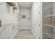 Well-organized walk-in closet with white wire shelving, wooden hangers, and wood-look flooring at 6123 Hidden Branch Dr, Apollo Beach, FL 33572