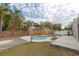 This beautiful backyard features a sparkling pool, a secure wooden fence, and tropical landscaping at 102 Shoreview Ln, Oldsmar, FL 34677