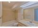 The bathroom has neutral tile in the shower/tub, and a large vanity with a big mirror at 102 Shoreview Ln, Oldsmar, FL 34677