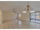 Open living space with tile floors, fan, and natural light from the sliding glass door at 102 Shoreview Ln, Oldsmar, FL 34677