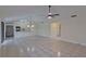 Open-concept living room features tile flooring, modern lighting, and a breakfast bar to the kitchen at 102 Shoreview Ln, Oldsmar, FL 34677