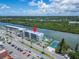Waterfront condo complex aerial view featuring a pool and tennis court near a waterway at 18325 Gulf Blvd # 407, Redington Shores, FL 33708