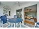 Waterfront balcony that views a living room with neutral coastal decor, ceiling fan and seating at 18325 Gulf Blvd # 407, Redington Shores, FL 33708
