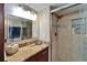 Updated bathroom featuring vanity with granite countertop and glass shower with tiled niche at 18325 Gulf Blvd # 407, Redington Shores, FL 33708