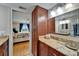 Bathroom vanity with granite countertop, cabinetry, and view into bedroom at 18325 Gulf Blvd # 407, Redington Shores, FL 33708