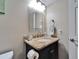 Close up of a bathroom vanity with granite countertop, framed mirror and chrome fixtures at 18325 Gulf Blvd # 407, Redington Shores, FL 33708