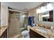 Bright bathroom featuring granite countertop, modern lighting, and a glass-enclosed shower at 18325 Gulf Blvd # 407, Redington Shores, FL 33708