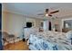 Bright bedroom featuring a TV on a dresser, ensuite bathroom access, and a cozy chair at 18325 Gulf Blvd # 407, Redington Shores, FL 33708