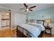 Cozy bedroom featuring a ceiling fan, ensuite laundry room, and charming nautical decor at 18325 Gulf Blvd # 407, Redington Shores, FL 33708