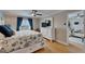 Spacious bedroom with a dresser, flat screen tv, and a glimpse into the living area at 18325 Gulf Blvd # 407, Redington Shores, FL 33708