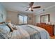 Comfortable bedroom featuring a ceiling fan, seaside decor, a wooden dresser, and bright lighting at 18325 Gulf Blvd # 407, Redington Shores, FL 33708