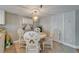 Bright dining room with coastal decor, modern lighting fixture, and tile floors at 18325 Gulf Blvd # 407, Redington Shores, FL 33708