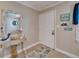 Entryway featuring tile flooring, decor, and a white front door at 18325 Gulf Blvd # 407, Redington Shores, FL 33708