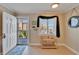 Condo entryway with light wood flooring, decor, and ocean views beyond the patio at 18325 Gulf Blvd # 407, Redington Shores, FL 33708