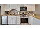 Updated kitchen featuring stainless steel appliances, white cabinets, and light countertops at 18325 Gulf Blvd # 407, Redington Shores, FL 33708