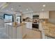 Bright kitchen with stainless steel appliances, granite countertops, and white cabinets at 18325 Gulf Blvd # 407, Redington Shores, FL 33708