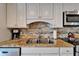 Updated kitchen features stainless steel appliances, granite countertop, and tiled backsplash at 18325 Gulf Blvd # 407, Redington Shores, FL 33708