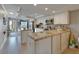 An open kitchen with two islands, stainless appliances, and white cabinets at 18325 Gulf Blvd # 407, Redington Shores, FL 33708