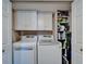 Laundry room with side-by-side washer and dryer and storage cabinets at 18325 Gulf Blvd # 407, Redington Shores, FL 33708