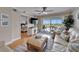 Inviting living room with waterfront views from the sliding doors, ceiling fan, and neutral coastal decor at 18325 Gulf Blvd # 407, Redington Shores, FL 33708