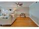 Open living room features hardwood flooring and a view of the balcony at 18325 Gulf Blvd # 407, Redington Shores, FL 33708