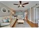 Bright living room showcasing plush sofas, ceiling fans and view to kitchen and waterfront balcony at 18325 Gulf Blvd # 407, Redington Shores, FL 33708