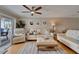 Comfortable living room with ceiling fan, neutral decor, plush seating, and a waterfront view at 18325 Gulf Blvd # 407, Redington Shores, FL 33708