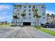 Exterior shot of building with parking garage, covered parking, and an adjacent parking lot at 18325 Gulf Blvd # 407, Redington Shores, FL 33708
