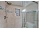 Close-up on a glass-enclosed shower with a tiled niche and chrome fixtures at 18325 Gulf Blvd # 407, Redington Shores, FL 33708
