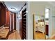 Expansive walk-in closet with custom wood organizers and ample storage space for clothes and accessories at 18325 Gulf Blvd # 407, Redington Shores, FL 33708